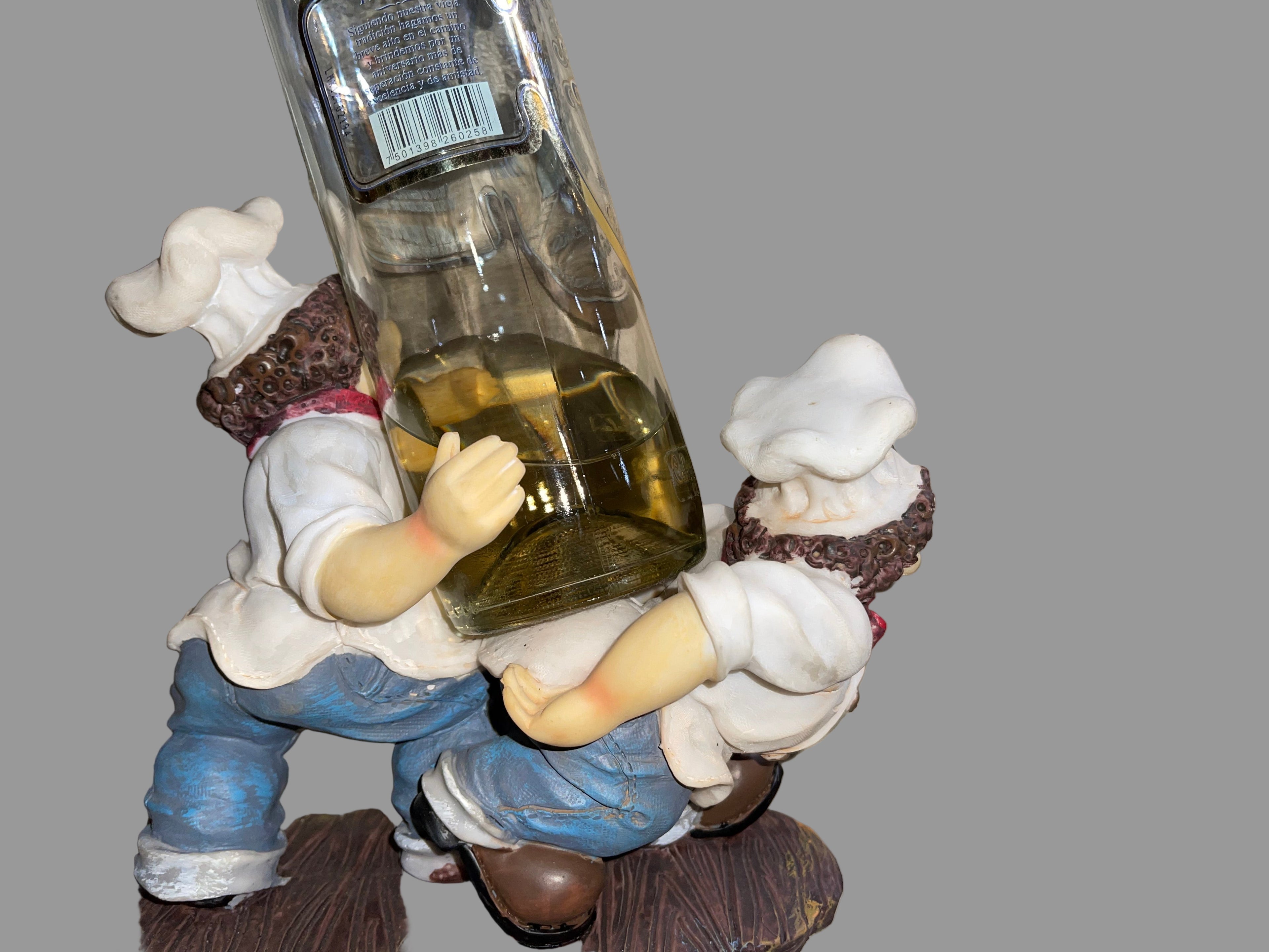 Toy figure holding a bottle on a striped surface