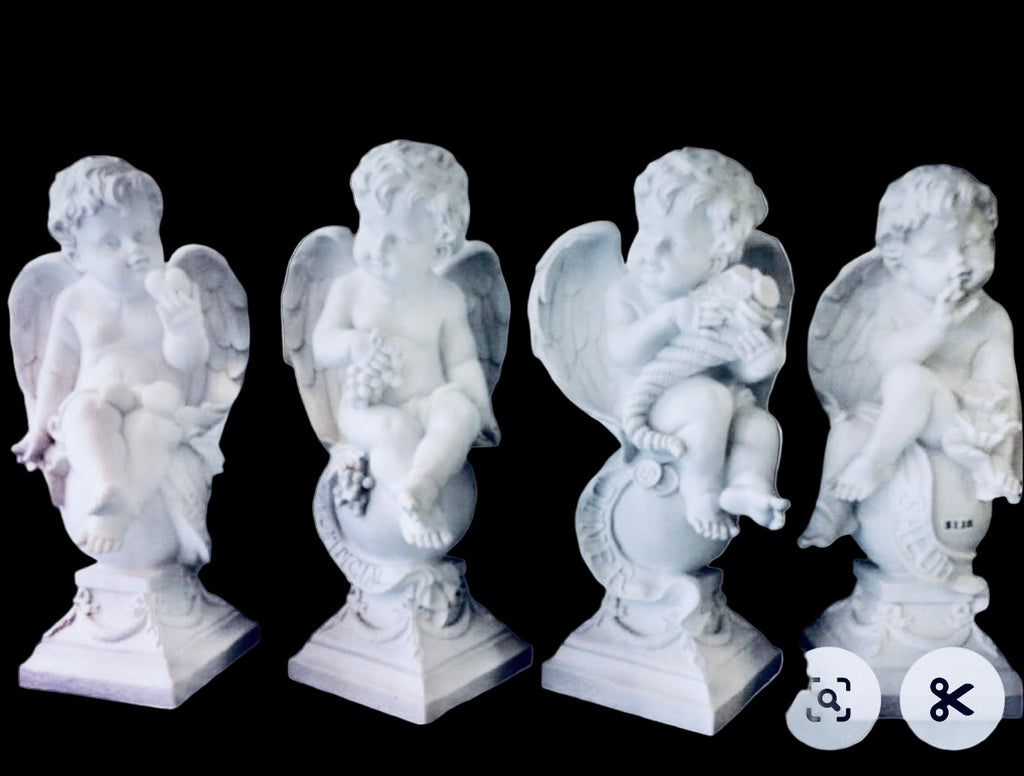 Four white angel statues on a white background