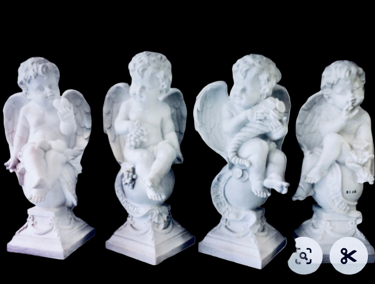 Four white angel statues on a white background